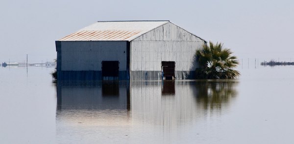 A lonely building rests silently in a newly formed Tulare Lake. 